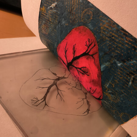 Ein Blatt mit Herzmotiv, halb abgehoben von der Druckplatte